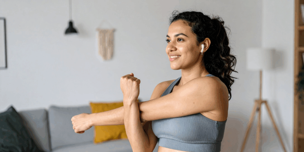 Woman stretching doing a micro workout. Image that is part of 20 Wellness Trends for 2026.