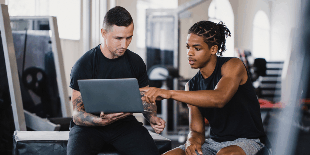 Personal training reviewing data with client. Image that is part of 20 Wellness Trends for 2026.